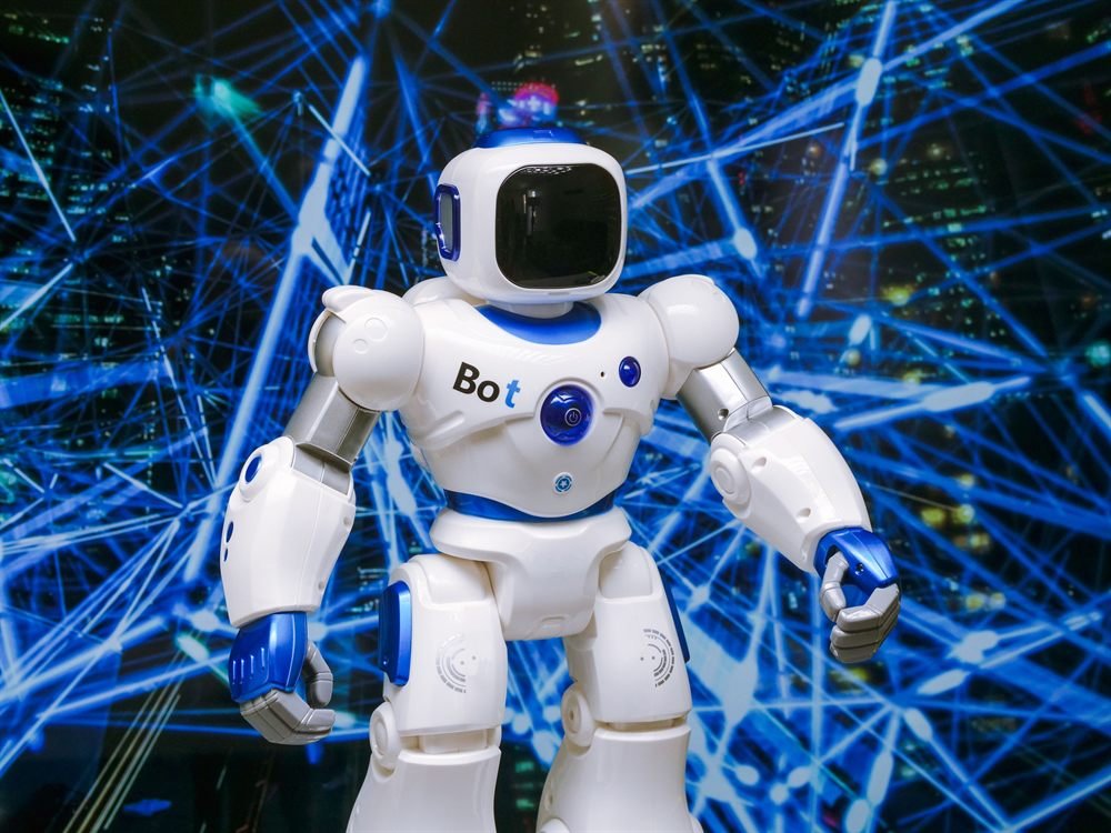 A white and blue toy robot standing against a lattice of blue light trails